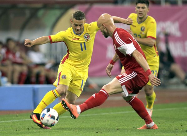 Romania's Gabriel Torje, left, vies for the ball with Georgia's Zourab Tsiskaridze, right, during the international friendly soccer match between Romania and Georgia on the National Arena stadium, in Bucharest, Romania, on Friday, June 3, 2016. (AP Photo/Vadim Ghirda)