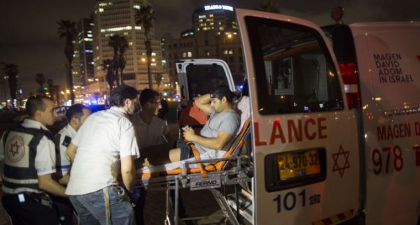 A wounded man is evacuated from the scene of a stabbing attack in Jaffa, a mixed Jewish-Arab part of Tel Aviv, Israel, Tuesday, March 8, 2016. (AP Photo/Oded Balilty)