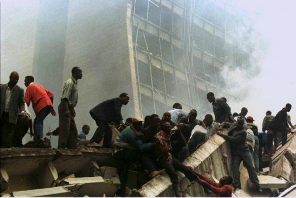 An injured man is removed from the wreckage after a bomb went off in Nairobi, Kenya, in this file photo from August 7, 1998.  REUTERS/Files