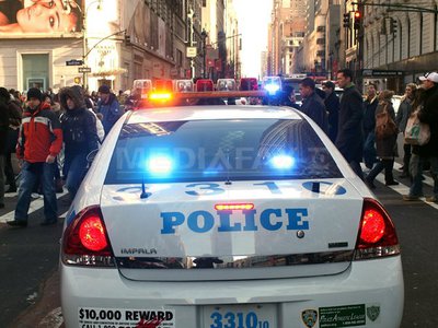 NEW YORK, NY - DECEMBER 20: Pedestrians cross the street as a New York City Police vehicle blocks off part of 34th St. in Manhattan on December 20, 2010 in New York City. The busy shopping street was closed temporarily for an investigation of a suspicious vehicle. Spencer Platt/Getty Images/AFP== FOR NEWSPAPERS, INTERNET, TELCOS & TELEVISION USE ONLY ==