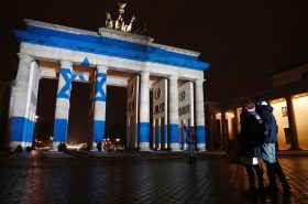 People look at the Brandenburg Gate with the Israeli flag projected onto in Berlin, on January 9, 2017 to pay tribute to the victims of the ramming attack in Jerusalem.  Israel was to bury four soldiers on January 9, 2017 killed when a Palestinian rammed a truck into troops visiting a popular Jerusalem tourist site in a stark reminder of tensions despite a recent lull in violence. / AFP / Odd ANDERSEN        (Photo credit should read ODD ANDERSEN/AFP/Getty Images)