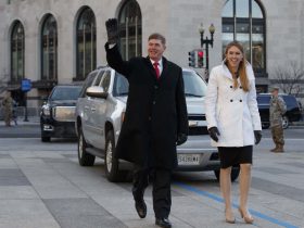 Army Sgt. Maj. Greg Lowery, left, playing the part of President-elect Donald Trump, and Army Spc. Sara Corry, playing the part of Melania Trump, walk along the parade route during a dress rehearsal for Inauguration Day, Sunday, Jan. 15, 2017, in Washington. (AP Photo/Evan Vucci)/DCEV101/17015542460871/1701151622