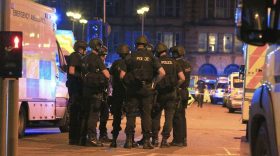 Armed police gather at Manchester Arena after reports of an explosion at the venue during an Ariana Grande gig  in Manchester, England Monday, May 22, 2017. Several people have died following reports of an explosion Monday night at an Ariana Grande concert in northern England, police said. A representative said the singer was not injured. (Peter Byrne/PA via AP)