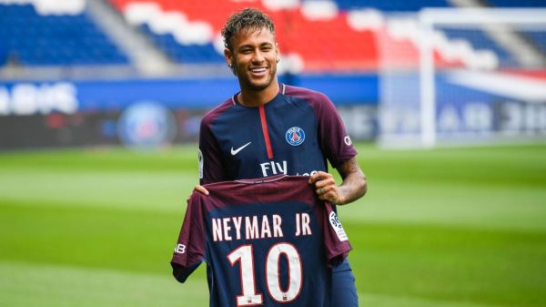 Brazilian superstar Neymar poses with his new jersey during his official presentation at the Parc des Princes stadium on August 4, 2017 in Paris after agreeing a five-year contract following his world record 222 million euro ($260 million) transfer from Barcelona to Paris Saint Germain's (PSG). Paris Saint-Germain have signed Brazilian forward Neymar from Barcelona for a world-record transfer fee of 222 million euros (around $264 million), more than doubling the previous record. Neymar said he came to Paris Saint-Germain for a "bigger challenge" in his first public comments since arriving in the French capital. / AFP PHOTO / Lionel BONAVENTURE        (Photo credit should read LIONEL BONAVENTURE/AFP/Getty Images)